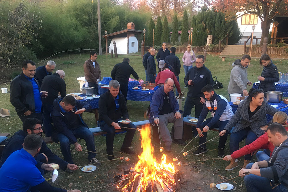 People from Kecskemét celebrate and stand around bonfire