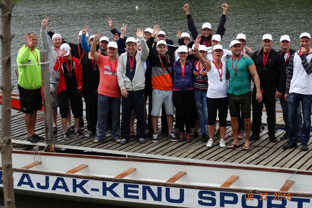 Canoe teams stand on the jetty