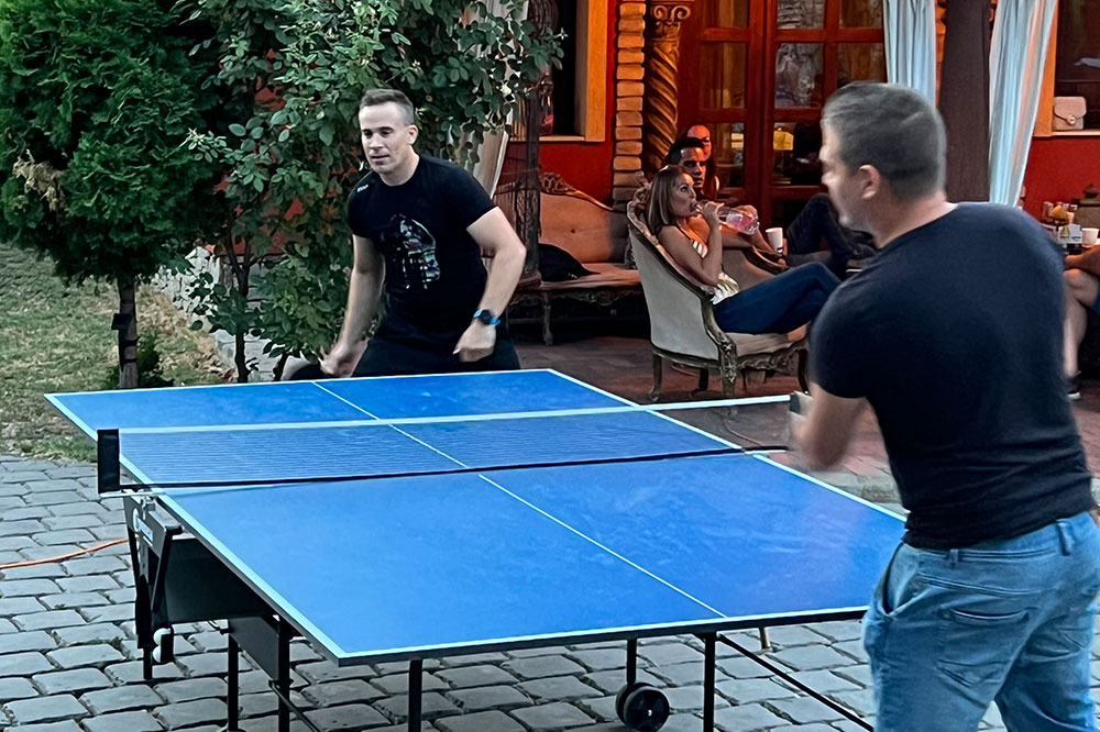 Two employees playing table tennis