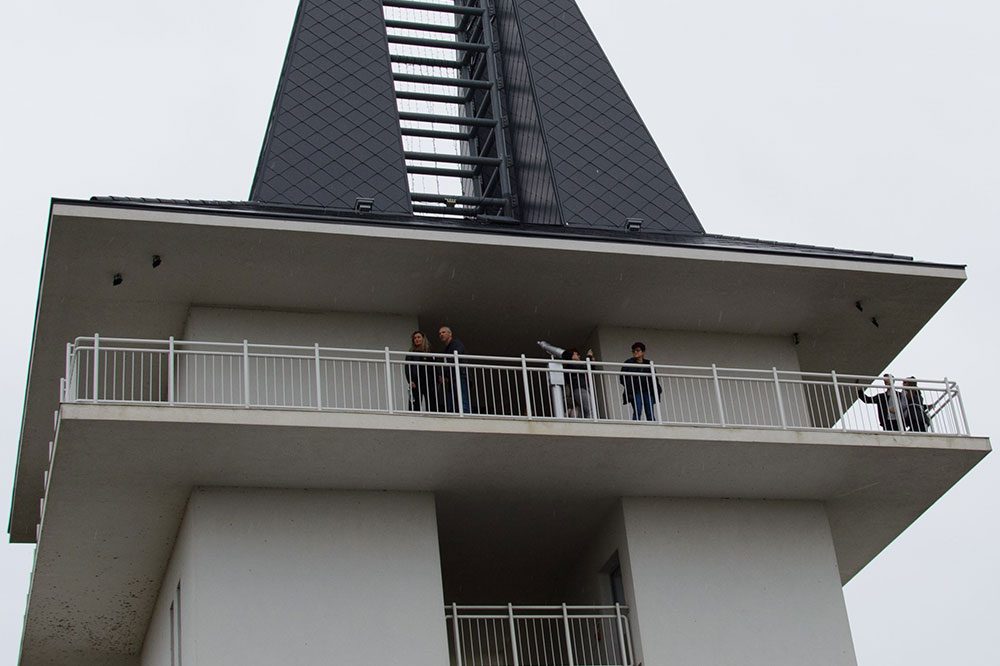 Frog perspective of employees looking down on an observation tower