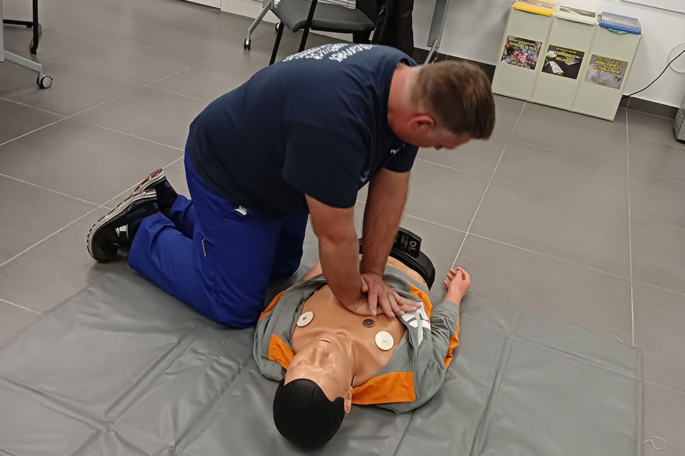 An employee practising first aid on a training dummy